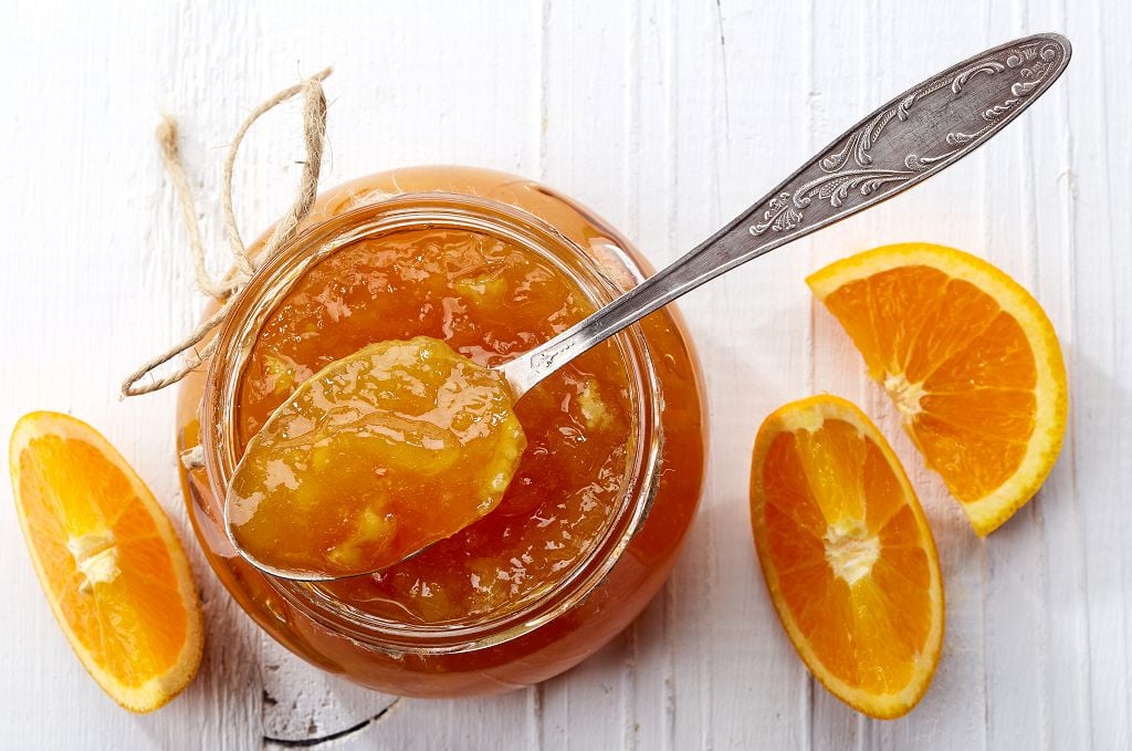 orange Freezer Jam, a spoon and slices of orange