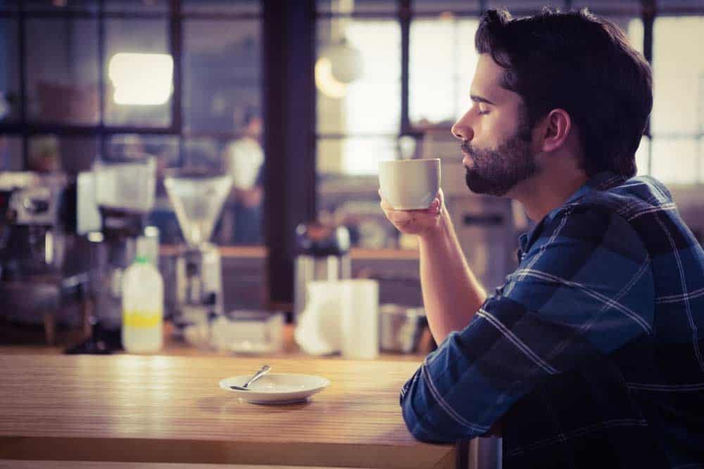 the man is drinking coffee